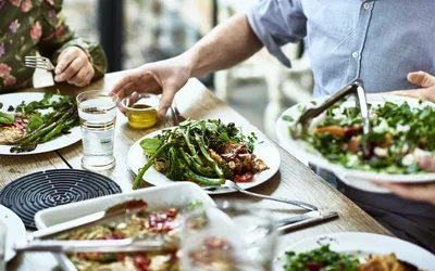 Cropped view of table laid with fresh homemade vegetarian food.