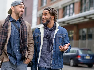 Smiley men walking down street