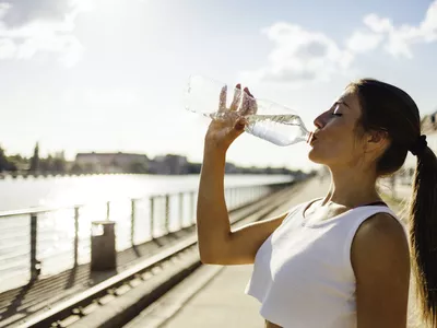 Woman running while drinking water