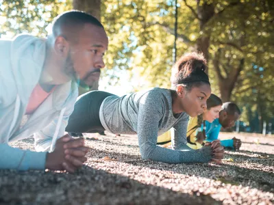 group doing the plank exercise outside