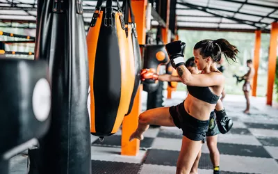 Woman kicking the punching bag