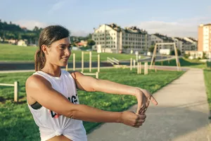 Woman doing tennis elbow wrist stretch