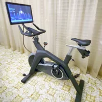Stryde The Bike set up on tile floor next to a window with curtains