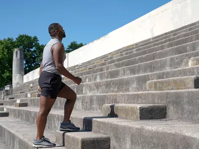 man walking up concrete steps