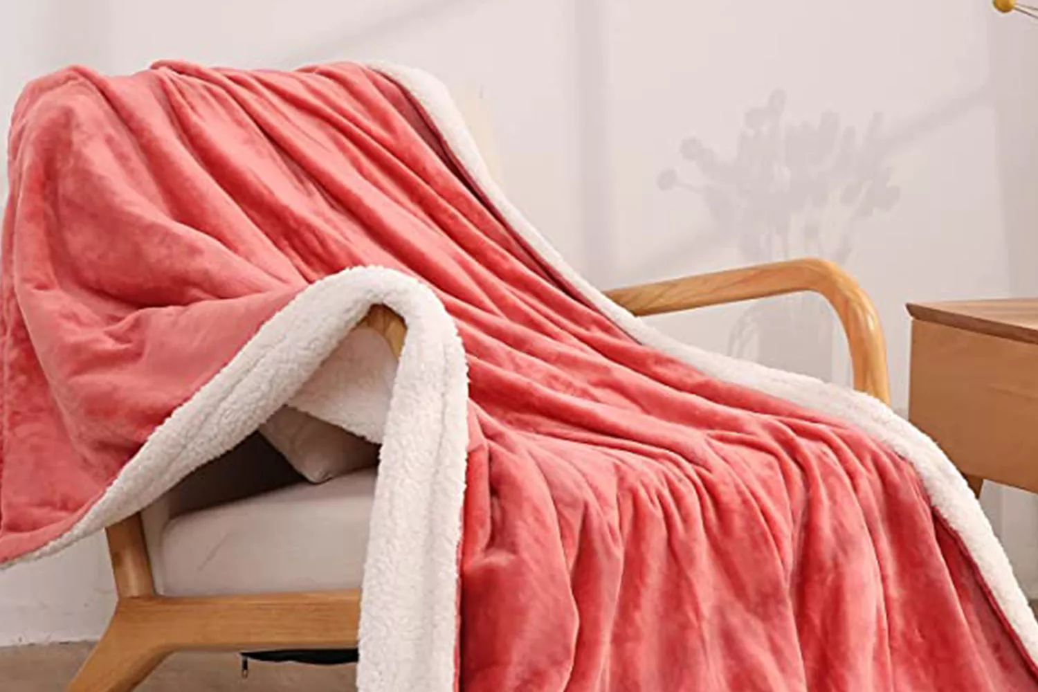 A CURECURE Heated Blanket draped over a chair