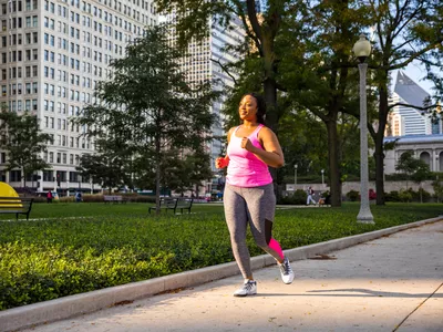 Woman running on sidewalk in a city