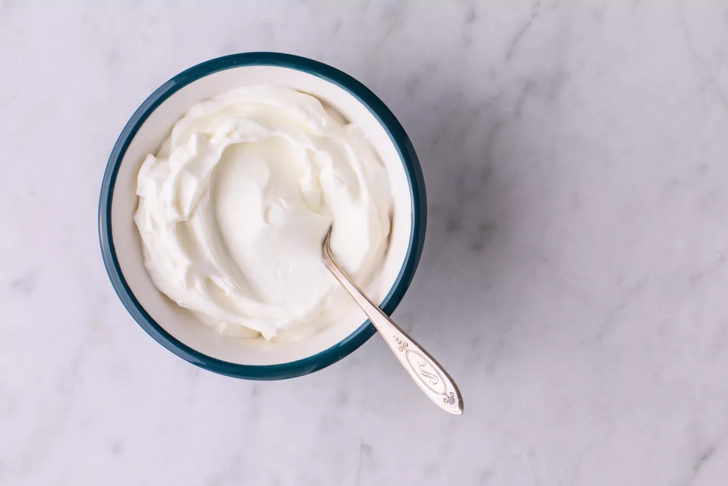 sour cream in a bowl with spoon