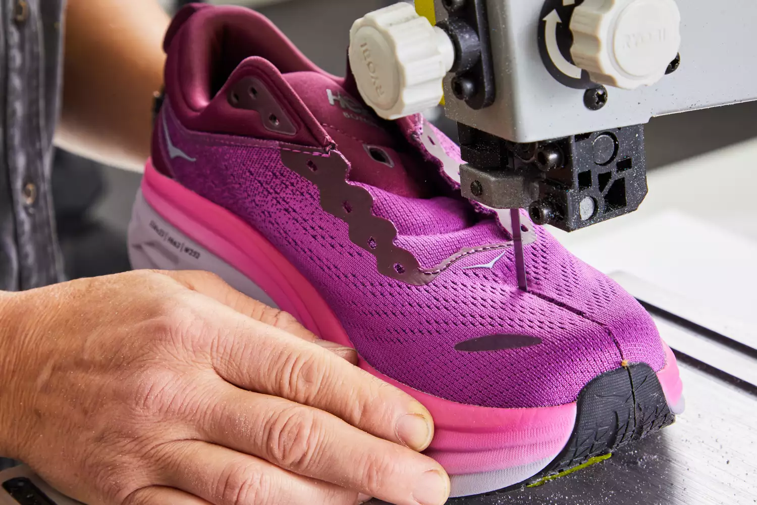 Hoka Women's Bondi 8 sneaker being cut in half with a band saw 