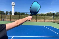 A person holds the HEAD Attitude Core Pickleball Paddle in the air