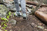 Person walking on wet land wearing Oboz Men's Bridger Mid B-Dry Hiking Boot