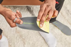 Hand folding a Superfeet Run Support Low Arch Shoe Insert