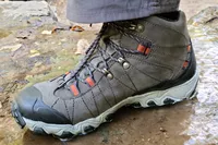 Foot on muddy ground wearing Oboz Bridger 9 Inch Insulated Waterproof Hiking Boot