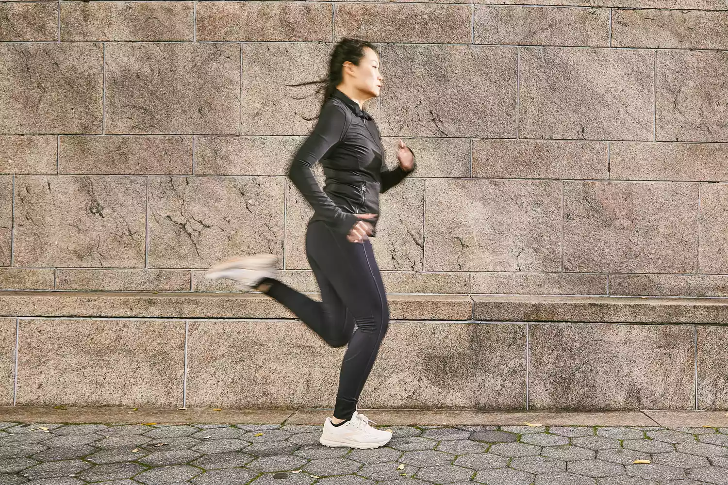 A person running outdoors wearing the Brooks Adrenaline GTS 23