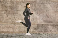 A person running outdoors wearing the Brooks Adrenaline GTS 23