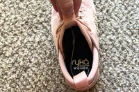A person holds the tongue on the Rykä Women's Podflow EZ Walking Sneaker open