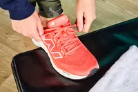 Person tying laces of New Balance Women's Fresh Foam X 880v14