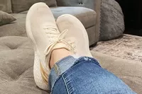 Person wearing Kizik Women's Athens Sneakers on couch